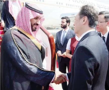  ??  ?? WARM WELCOME: Deputy Crown Prince Mohammed bin Salman is welcomed by China’s Vice Minister of Foreign Affairs Wang Chao on arrival in Beijing on Monday. (SPA)