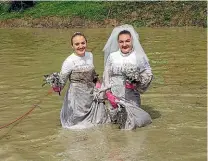  ??  ?? Russian brides hold on tight to their bouquets.