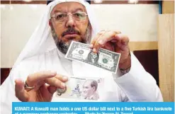  ??  ?? KUWAIT: A Kuwaiti man holds a one US dollar bill next to a five Turkish lira banknote at a currency exchange yesterday. — Photo by Yasser Al-Zayyat