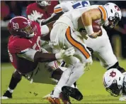  ?? MICKEY WELSH — THE MONTGOMERY ADVERTISER VIA AP ?? Alabama defensive lineman Tim Smith, left, brings down Auburn quarterbac­k Bo Nix for a sack in Saturday’s game.