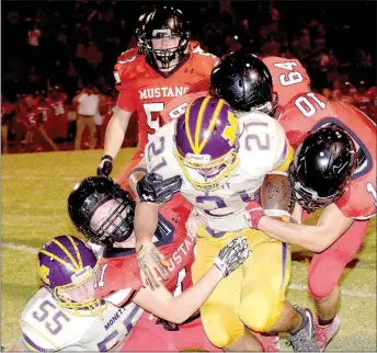  ?? RICK PECK/MCDONALD COUNTY PRESS ?? McDonald County’s David Roark (11), Caleb Curtis (10) and Trey Black (64) bring down Monett’s Patrick Valentine during the Mustangs 21-18 win on Sept. 29 at MCHS.