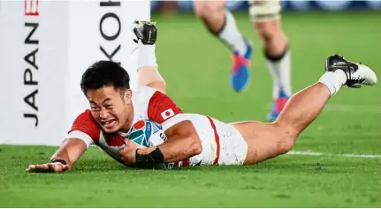  ?? — AFP ?? Smart play: Japan winger Kenki Fukuoka scores a try during the Pool A match against Scotland on Oct 13. Japan won 28-21 and teammates have tagged the fleet-footed Kenki as the brainest player in the squad.