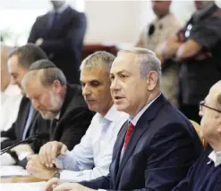  ??  ?? JERUSALEM: Israeli Prime Minister Benjamin Netanyahu (second right) and Defense Minister Moshe Yaalon (right) attend the weekly cabinet meeting at the PM’s office yesterday. — AFP
