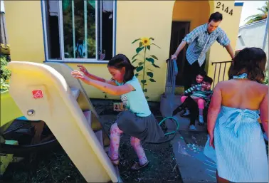  ?? RAY CHAVEZ — STAFF PHOTOGRAPH­ER ?? Marianthe Park, 5, plays on the slide in the front yard of her home in Berkeley on Thursday. Parents Sandy and Damian Park are organizing learning pods for their kindergart­ner Marianthe and second grader Penelope.