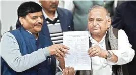  ??  ?? Samajwadi Party supremo Mulayam Singh Yadav with party’s UP President Shivpal Yadav showing the candidates’ list for UP Assembly elections at a press conference at the party office in Lucknow on Wednesday