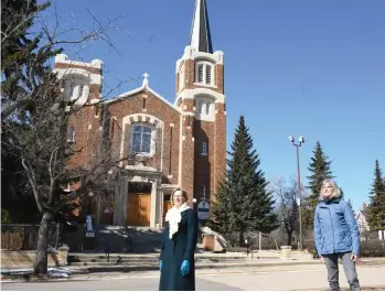  ??  ?? Janie Fries and Rosalie Boots stand outside St. Joseph Roman Catholic Church and listen to the bells ring out, as part of a new initiative to offer hope to the community during the coronaviru­s. Photo by Jason G. Antonio