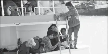  ?? AP File Photo ?? A foreign fishing crew checks for damage Nov. 6, 2015, on the Sea Queen IIA at Fisherman’s Wharf in San Francisco. Two Indonesian fishermen ran away from the vessel’s sister ship, the Sea Queen II, which is owned by the same captain.