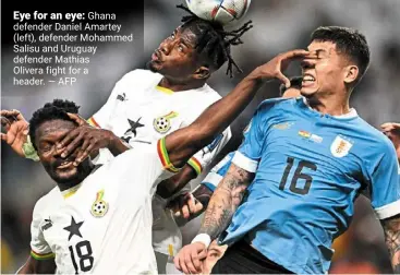  ?? ?? eye for an eye: Ghana defender daniel amartey (left), defender mohammed Salisu and uruguay defender mathias Olivera fight for a header. — AFP
