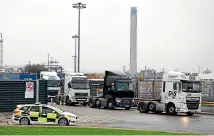  ?? GETTY IMAGES ?? Lorries are seen outside the Purfleet Thames Terminal on October 23, 2019 in Purfleet, Essex. Essex police said that a lorry containing 39 bodies, found in the nearby town of Grays, likely arrived in Purfleet overnight on a freight ferry from Zeebrugge, Belgium.