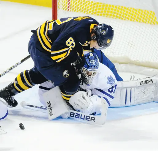  ?? DOUG BENZ / REUTERS ?? Marcus Foligno, who collided with Leafs goalie Ben Scrivens in the second period, picked up two assists in Buffalo’s win.