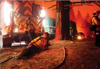  ??  ?? Captain Garrett Grigg rests during an overnight shift battling a blaze in Eldorado National Forest, California