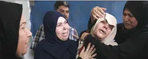  ??  ?? Relatives of Palestinia­n Ahmed El Taweel, who was killed the day before during a protest along the border fence, mourns during his funeral in Nuseirat camp, in the central Gaza Strip, yesterday.