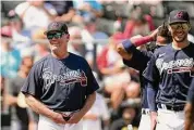  ?? Brynn Anderson/Associated Press ?? Atlanta Braves manager Brian Snitker and players during a spring training game on Feb. 25.