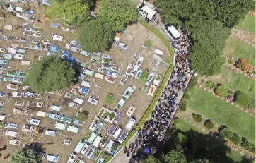  ??  ?? CIENTOS DE familiares y amigos acompañaro­n la carroza fúnebre al cementerio, en San Salvador