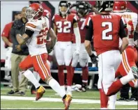  ?? AP/CHUCK BURTON ?? Kansas City safety Eric Berry (left) heads toward the end zone after intercepti­ng a two-point conversion pass late in the fourth quarter of Sunday’s game against Atlanta. Berry also had a 37-yard intercepti­on return for a touchdown in the second...