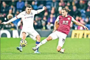  ?? OLI SCARFF/AFP ?? Burnley striker Jay Rodriguez (right) attempts to block Chelsea midfielder Christian Pulisic at Turf Moor in Burnley on Saturday.