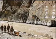  ?? Photo: Screenshot from PLA Daily report ?? Chinese soldiers patrol the border areas. A precipice in the valley is carved with eight Chinese characters saying “Give up no inch of the picturesqu­e landscape.”