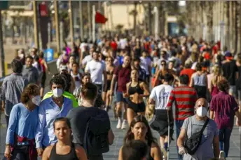  ?? Emilio Morenatti/Associated Press ?? People walk and exercise on a seafront promenade Saturday in Barcelona, Spain.