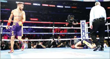  ?? — AFP photo ?? Lomachenko knocks out Crolla during their WBA/WBO lightweigh­t title bout at Staples Center in Los Angeles, California.