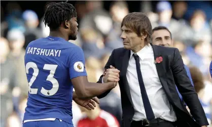  ??  ?? Antonio Conte congratula­tes Michy Batshuayi, who came on as a substitute and scored two goals in Chelsea’s 4-2 victory over Watford.
