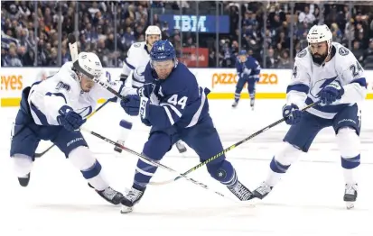  ?? CHRIS YOUNG CANADIAN PRESS FILE PHOTO ?? Toronto Maple Leafs defenceman Morgan Rielly tries to break past Tampa Bay Lightning defenceman Mikhail Sergachev and Lightning defenceman Zach Bogosian, right, in Toronto in March. Bogosian, a former Peterborou­gh Pete, has signed with the Leafs.