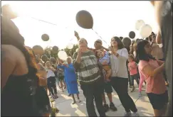  ??  ?? Ruben Rodriguez Jr.’s father, Ruben Rodriguez Sr., middle, with wife, Nina Rodriguez, and daughter Hannah Rodriguez, holding Ruben’s nephew, Ezra Rodriguez, 11 months, get ready to release balloons with messages written to Ruben. Ruben Rodriguez Jr.’s aunt, Cynthia Herrera, middle, is embraced by his other aunt, Stella Rodriguez, left, and cousin ,Stella Chavez, right, after a balloon release in his honor as family and friends of Ruben Rodriguez Jr., who was shot and killed in May, celebrate his birthday at Micke Grove Park in Lodi on Friday.