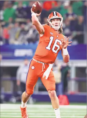  ?? Tom Pennington / Getty Images ?? Trevor Lawrence of the Clemson Tigers passes in the first half against the Notre Dame Fighting Irish during the College Football Playoff semifinal Goodyear Cotton Bowl Classic at AT&amp;T Stadium on Saturday in Arlington, Texas.