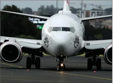  ?? (Bloomberg News WPNS/Brendon Thorne) ?? A Boeing 737 jet operated by Virgin Australia Holdings sits at Sydney Airport earlier this month.