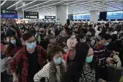  ?? KIN CHEUNG — THE ASSOCIATED PRESS ?? Passengers wear protective face masks at the departure hall of the high speed train station in Hong Kong on Thursday.