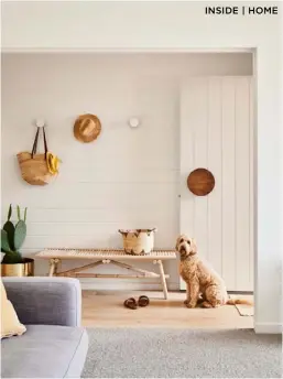  ??  ?? ENTRANCE (above) A handy Ikea bench — and Clive — near the door. Carpet, Solomons Flooring. Gold pot, Cactus Designs Indoor Plants.
KITCHEN (below) “Make design decisions based on your lifestyle,” advises Briony, whose open-plan kitchen has easy access to a north-facing deck and pool. The stools were made by Nat Starr, a friend of Briony’s.
LIVING AREA (opposite) The Plush sofa gets plenty of use. Floor, raw oak with a Woca white pre-colour finish. Ottoman and cushions, Rigby’s Homewares. Walls, Dulux Natural White. Artwork by Natalie Jade.