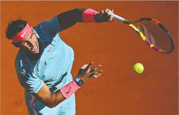  ?? MARTIN BUREAU / AFP via Gety Images ?? Spain’s Rafael Nadal serves to American Sebastian Korda on his way to a 6-1, 6-1, 6-2 victory during their men’s singles fourth round tennis match
on Day 8 of the 2020 French Open tennis tournament at Roland Garros in Paris on Sunday.