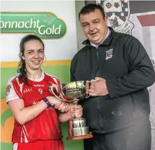  ??  ?? St Nathy’s captain Ann-Marie Coleman receives the cup from Keith Gilroy, Sligo LGFA chairman on Saturday. Pic: Tom Callanan.