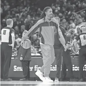  ?? BILL STREICHER/USA TODAY SPORTS ?? Injured Grizzlies guard Ja Morant dribbles the ball during a timeout in the third quarter against the 76ers at Wells Fargo Center.