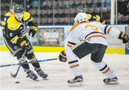  ??  ?? Victoria’s Matt Doran, left, tries to elude check by Nanaimo‘s Ty Pickering at The Q Centre Tuesday night.