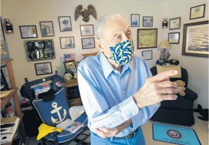  ?? BOB SELF/AP ?? Bob Johnson gestures in the room of his Jacksonvil­le home that contains mementos from his U.S. Navy career and his Antarctic exploratio­ns.