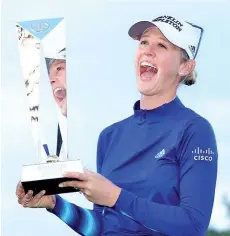  ??  ?? Jessica Korda poses with the trophy after winning the Diamond Resorts Tournament of Champions at the Four Seasons Golf & Sports Club in Lake Buena Vista, Florida.