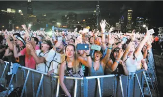  ?? Rob Grabowski / Associated Press ?? Music fans pack Chicago’s Grant Park for the Lollapaloo­za festival. Investigat­ors say Las Vegas shooter Stephen Paddock booked a hotel room overlookin­g the park but never checked in.