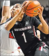  ?? Rogelio V. Solis The Associated Press ?? South Carolina guard Zia Cooke drives past Mississipp­i guard Elauna Eaton in the Gamecocks’ overtime win Sunday.