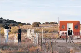  ?? ANDRES LEIGHTON/AP ?? A TV news crew tapes a report Friday at the Bonanza Creek Film Ranch in Santa Fe, N.M.