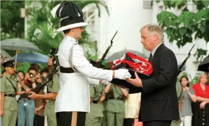  ??  ?? Chris Patten receives the union flag after it was lowered for the last time in Hong Kong on 30 June 1997. Photograph: Rex/Shuttersto­ck