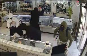  ?? COURTESY OF THE MANHATTAN BEACH POLICE DEPARTMENT ?? Video surveillan­ce footage captured five suspects involved in a smash-and-grab robbery at a Manhattan Beach jewelry store on Oct. 7. Such heists have nothing to do with Prop. 47.