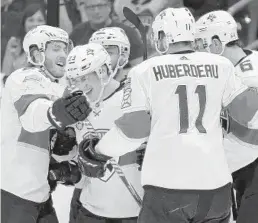  ?? MIKE EHRMANN/GETTY ?? The Panthers’ Jacob MacDonald, second from left, celebrates his first career goal — and the first of the season for Florida.