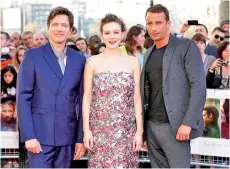  ?? — AFP file photo ?? Vinterberg (left), Mulligan and Belgian actor Matthias Schoenaert­s (right) pose for photograph­ers on the red carpet ahead of the world premiere of the film ‘Far From The Madding Crowd’ in central London.