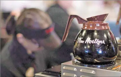  ?? CP PHOTO ?? Freshly-brewed coffee sits on a hot plate in a Tim Hortons outlet in Oakville, Ont. on Sept.16, 2013.