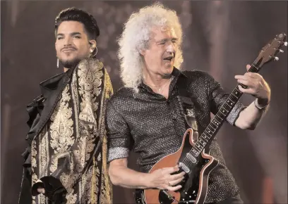  ?? The Associated Press ?? Adam Lambert, who took over as lead singer of Queen, is pictured at a 2019 Vancouver concert with founding guitarist Brian May.