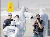  ?? AP PHOTO ?? Investigat­ive police officer work by a body under a white sheet outside Marseille ‘s main train station Sunday, Oct. 1, 2017 in Marseille, southern France. A man with a knife attacked people at the main train station in the southeaste­rn French city of...