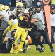  ??  ?? Colorado safety Ryan Moeller, right, works to make a tackle during a game against Oregon last fall at Folsom Field. Jeremy Papasso, Daily Camera