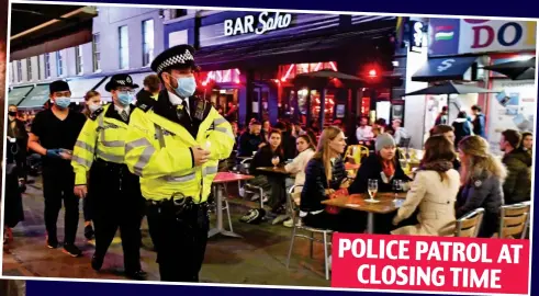  ??  ?? POLICE PATROL AT CLOSING TIME Masked and ready: Officers in Soho, central London, on Thursday