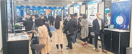  ?? PHOTOS BY ANUCHA CHAROENPO ?? Visitors at the 16th Asian Finance Forum (AFF) look at booths and exhibits of financial institutio­ns and start-up companies from various countries, Hong Kong and mainland China. The forum ended yesterday.