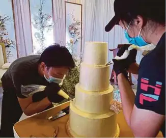  ??  ?? FROM RIGHT: Baking requires precision in its recipe applicatio­n; The founder of Elevete and his signature macarons; Edwin Chan and his wife Ng Aik Sha decorating a wedding cake.